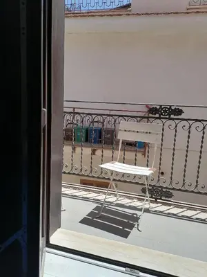 a white bench sitting on top of a balcony at Casa di Cecilia in Castellammare del Golfo