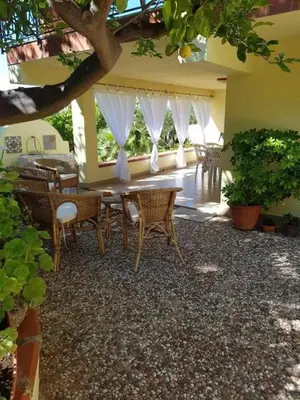 a dining room with a table and chairs at Casa Rosalba in San Vito lo Capo