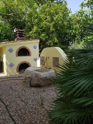 a building with a dome and a rock in a yard at Casa Rosalba in San Vito lo Capo