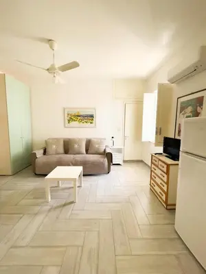 a living room with a couch and a table at casa delle rose in Isola delle Femmine