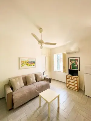 a living room with a couch and a table at casa delle rose in Isola delle Femmine