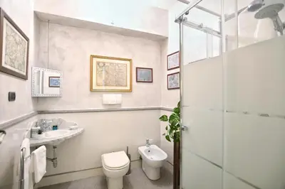 a bathroom with a toilet and a sink and a shower at Al Massimo Piacere in Palermo