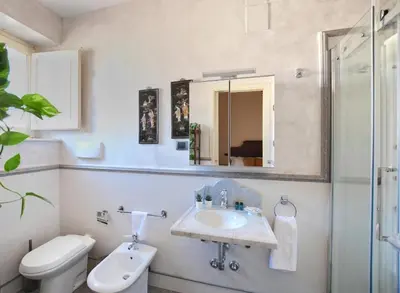 a bathroom with a sink and a toilet and a mirror at Al Massimo Piacere in Palermo