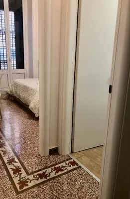 an open door to a room with a bedroom at La Bella Balla-rò Rooms in Palermo