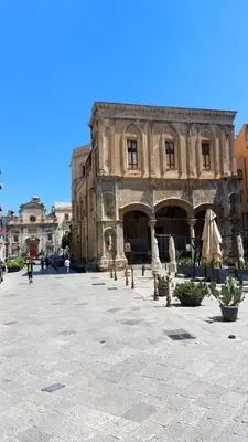 an old building with closed umbrellas in a courtyard at David house alla Vucciria in Palermo