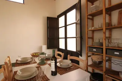 a dining room with a table and chairs and a window at Antico Baglio Siciliano in Balestrate