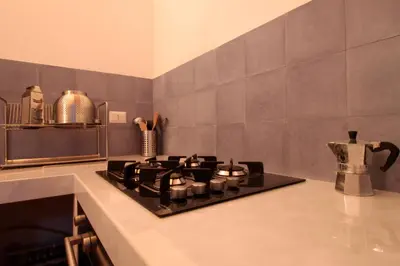 a kitchen with a stove top oven in a kitchen at Antico Baglio Siciliano in Balestrate