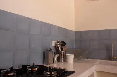 a kitchen with a counter top with utensils in a room at Antico Baglio Siciliano in Balestrate