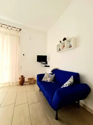 a blue couch sitting in a living room at Casa Vacanze Sea-Life in Alcamo Marina