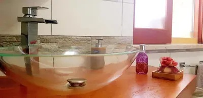 a bathroom sink with a bowl on a wooden counter at Casa Vacanze Sea-Life in Alcamo Marina