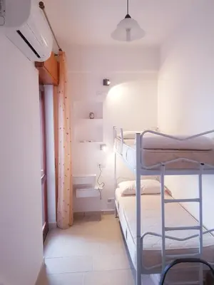 a bedroom with two bunk beds and a window at Casa Vacanze Sea-Life in Alcamo Marina
