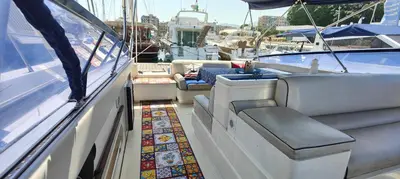 a boat with seats and a rug on the deck at Desirè Charming House Boat in Palermo