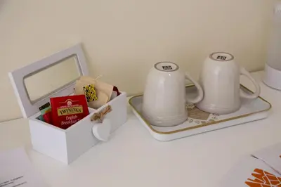 two white coffee mugs and a box on a table at Il Sonaglio in Palermo