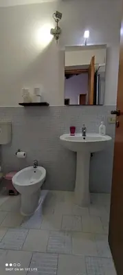 a bathroom with a sink and a toilet at Casa Samu in Palermo