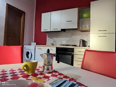 a kitchen with white cabinets and a table with a blender at Casa Samu in Palermo