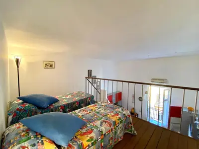 a bedroom with two beds and a staircase at Elegante appartamento in centro in Palermo