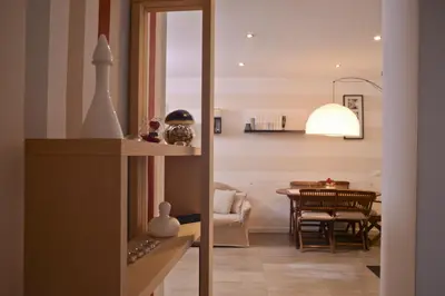a living room and dining room with a dining table at Marilù in Palermo