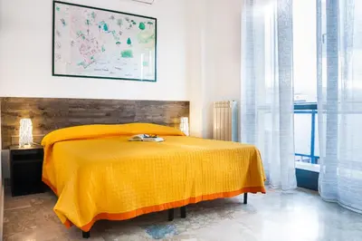 a bedroom with a bed with a yellow blanket at Darrè in Palermo