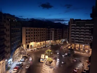 a city street at night with cars and buildings at Darrè in Palermo
