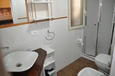 a bathroom with a sink and a toilet at Villetta in Centro Storico in Caccamo