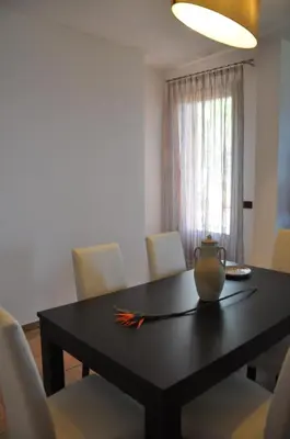 a dining room table with a vase on top of it at Villa Mediterranea in Scopello