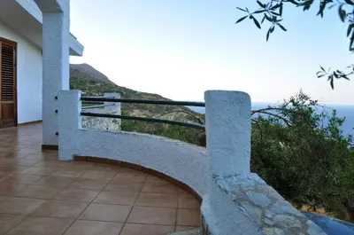 a stone bench with a view of the ocean at Villa Mediterranea in Scopello
