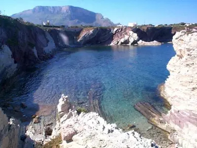 a large body of water on a rocky cliff at By the Sea in Terrasini