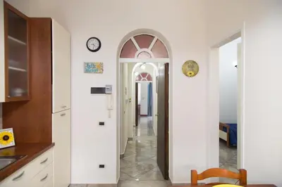 a hallway with an archway leading into a room at By the Sea in Terrasini
