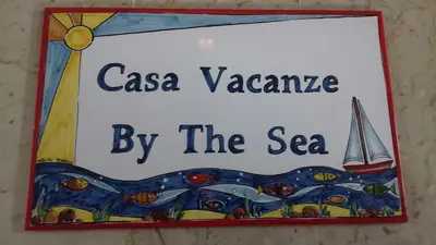 a sign that reads casa vacanza by the sea at By the Sea in Terrasini