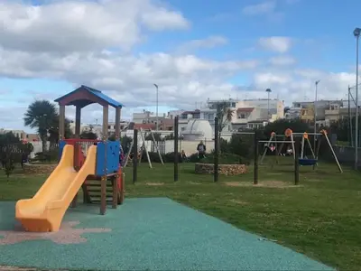 a playground with a slide in a park at By the Sea in Terrasini