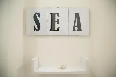a shelf with black and white signs on a wall at By the Sea in Terrasini