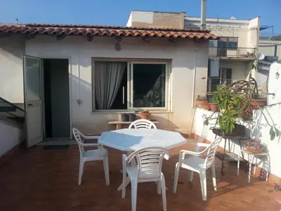 a patio with a table and chairs on a balcony at Bed & Breakfast Sweet Politeama in Palermo