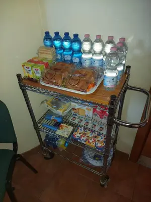 a cart full of water bottles and food and drinks at Bed & Breakfast Sweet Politeama in Palermo