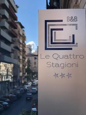 a sign for a la quattro station on a street at Le Quattro Stagioni - Rooms & Suites in Palermo