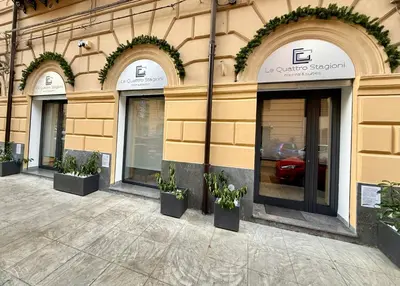 a facade of a building with windows and potted plants at Le Quattro Stagioni - Rooms & Suites in Palermo
