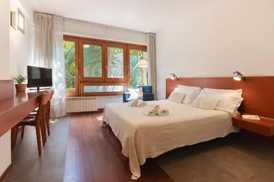 a bedroom with a large bed with two towels on it at Marbela Apartments & Suites in Palermo