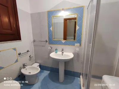 a bathroom with a sink and a mirror and a toilet at Casa Marcella San Vito Lo Capo in San Vito lo Capo