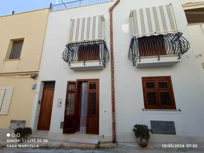 a white house with two balconies and two doors at Casa Marcella San Vito Lo Capo in San Vito lo Capo