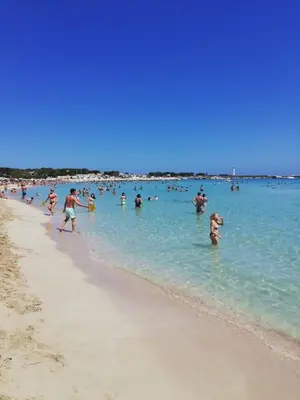a group of people in the water at the beach at Casa Marcella San Vito Lo Capo in San Vito lo Capo