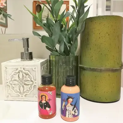 two bottles of essential oils sitting next to a vase at Guest House Antichi Ulivi in Mondello
