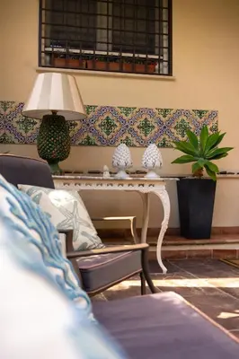 a living room with a table and a chair at Guest House Antichi Ulivi in Mondello