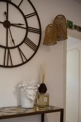a large clock on the wall next to a table at Guest House Antichi Ulivi in Mondello