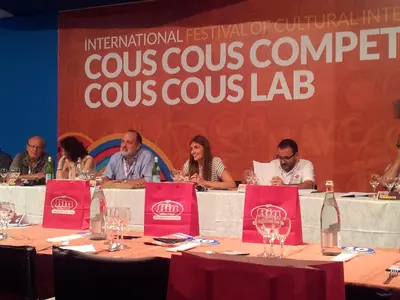 a group of people sitting at tables in front of a stage at HOME HOLIDAY PINO&FABIANA in San Vito lo Capo