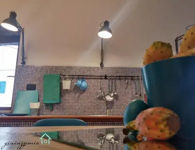 a kitchen with a counter with a sink and a counter sidx sidx at GiuiuzzaMia in Palermo