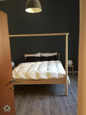 a bed in a bedroom with a black wall at GiuiuzzaMia in Palermo
