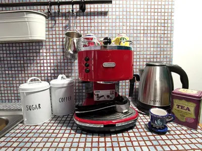 a red coffee maker sitting on a kitchen counter at GiuiuzzaMia in Palermo