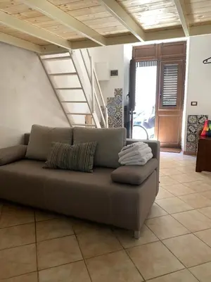 a brown couch sitting in a living room at Alice's Apartment in Castellammare del Golfo