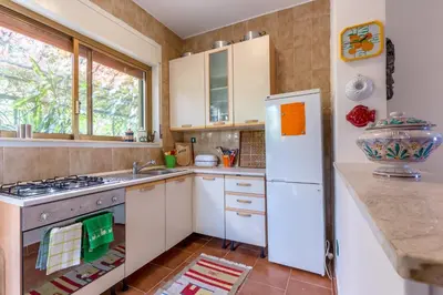 a kitchen with a stove and a refrigerator at Villa Violetta in Carini