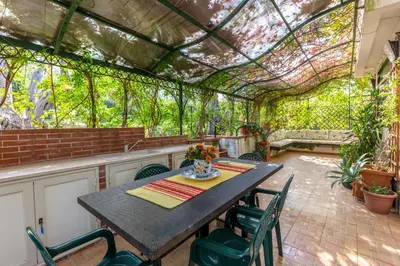 an outdoor dining room with a table and chairs at Villa Violetta in Carini