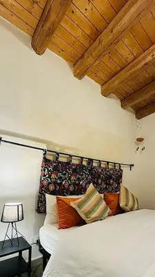 a bedroom with a white bed and wooden ceilings at Camerini di Santa Cecilia in Palermo